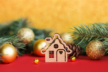 Christmas Wooden Ornaments house on red Christmas background. Concept staying at home. Space for...