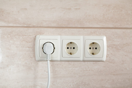 Electrical plug in outlet socket at home.