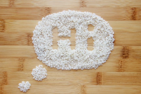 White Rice grains on Bamboo background conceptの写真素材