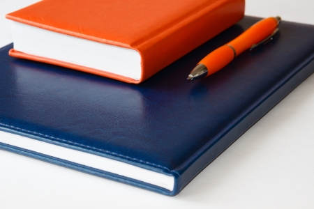 Notebooks and pen  on a light backgroundの写真素材