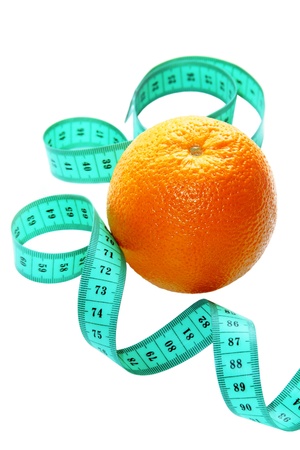 Healthy lifestyle and diet - orange fruit and measuring tape isolated on a white backgroundの写真素材