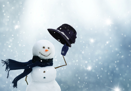 New year greeting card with copy-space.Happy snowman standing in christmas landscape.Snow backgroundの写真素材