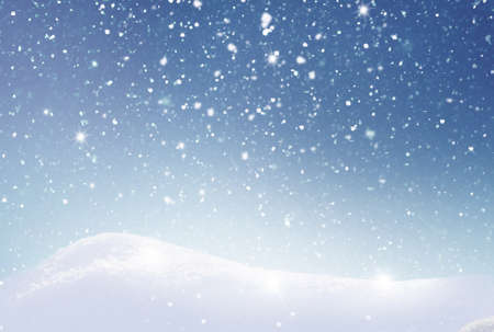 Winter background with snow and blurred bokeh.Merry Christmas and happy New Year greeting card with copy-space. Snowy winter landscape with fir tre and snowfall.の写真素材
