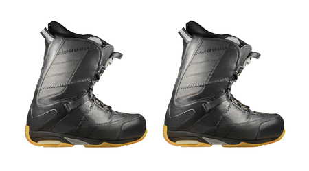 Pair of black snowboard boots isolated on white background. Side view of sport shoesの写真素材
