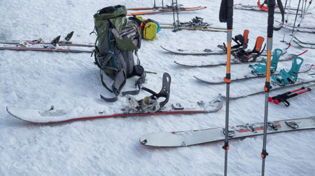 Group of splitboard, skis and poles on snow. Sport equipment for ski touringの写真素材