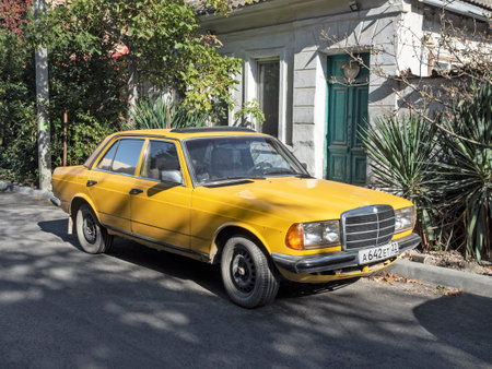 Barnaul, Russia - October 7, 2021: Old vintage Mercedes-Benz car of yellow color