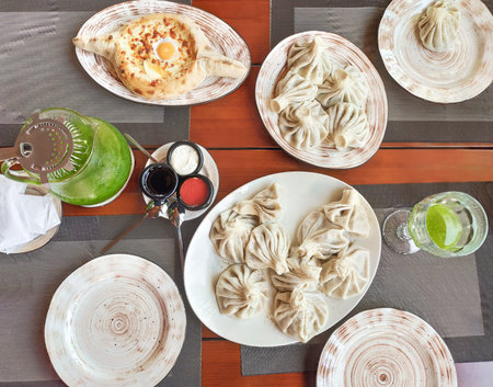 Georgian cuisine with khinkali, Adjarian khachapuri and tarhun lemonadeの写真素材