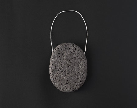 Charcoal konjac sponge on black backgroundの写真素材