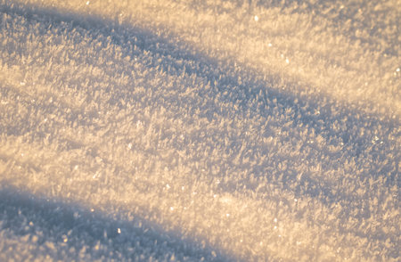 Snow with sunlight and shadowsの写真素材