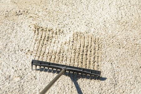 Sand rake in a golf trap, raking the sandの写真素材