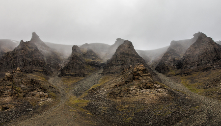 Fog and cliffs, mountain peak landscape. Spitsbergen, Svalbard, Norwayの写真素材