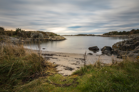Seascape with rocks, sea and clouds. Grimstad in Norwayの写真素材