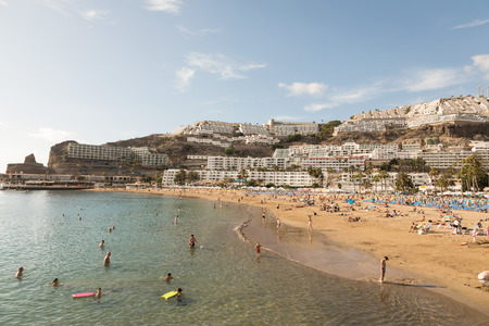 GRAN CANARIA, SPAIN - DECEMBER 10, 2017: People visit Puerto Rico Beach in Gran Canaria, Spain. Canary Islands had 13.3 million visitors in 2016.のeditorial素材