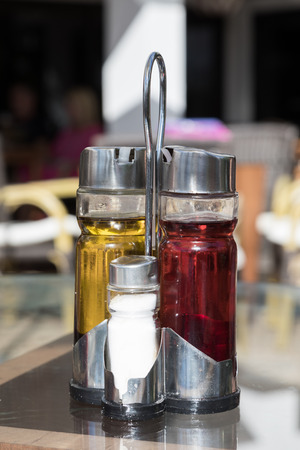 Olive oil and vinager on a table of street cafeの写真素材