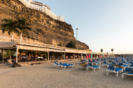 Amadores, Gran Canaria in Spain - December 14, 2017: Sunbeds, shops and resturants on the popular Amadores Beach.のeditorial素材