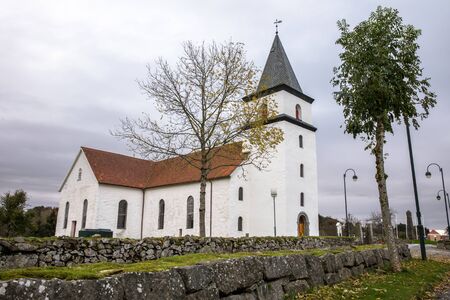 Farsund, Norway - October 2019: Vanse Kirke, an old white stone church from 1037.のeditorial素材