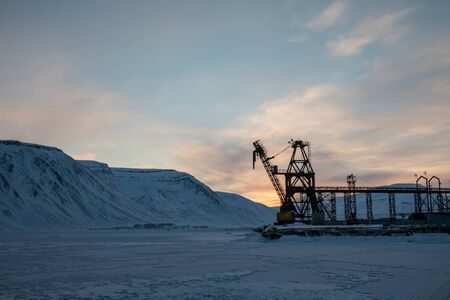 Crane in winter landscape at Pyramiden. Abandoned Soviet Russian settlement in Svalbard, Norway.の写真素材