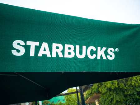 Kuta, Bali, December 2018: Starbucks logo on a green pavilion roof. Starbucks is the largest...
