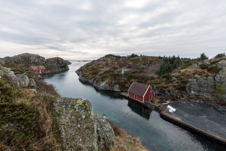 The Rovaer archipelago in Haugesund, in the norwegian west coast. The bay with the red hostel in front. Rovaer is a small group of islands, with only around 110 inhabitants.のeditorial素材