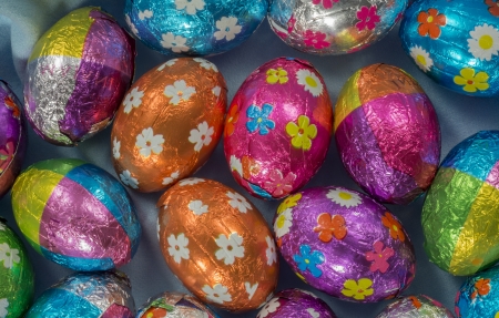 Multi coloured chocolate eggs on blueの写真素材