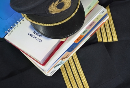 Captain uniform and aircraft check list for aircraft emergency procedureの写真素材