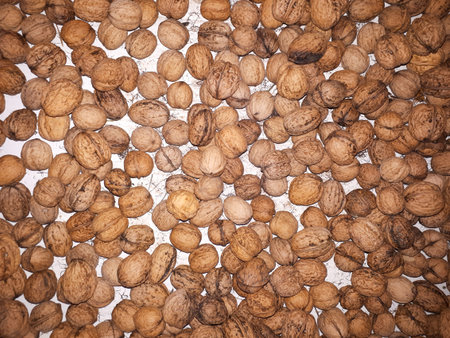 Top view of walnuts on a white surface under the lights