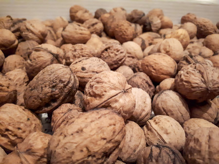 Closeup of walnuts on the table under the lights with a blurry background
