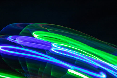 abstract background with blue and green lights in motion and copy space for text. futuristic bright backdropの写真素材