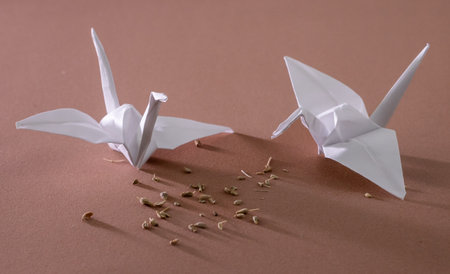 Paper origami birds on a brown background. Close-up.の写真素材