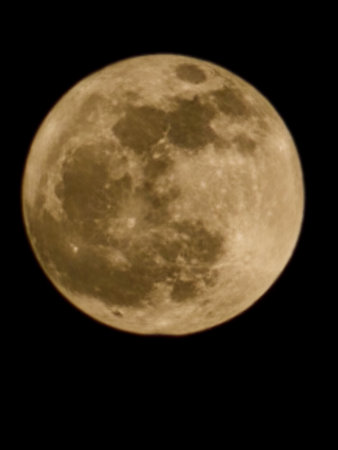 Close up of a full moon in the night sky in black backgroundの写真素材
