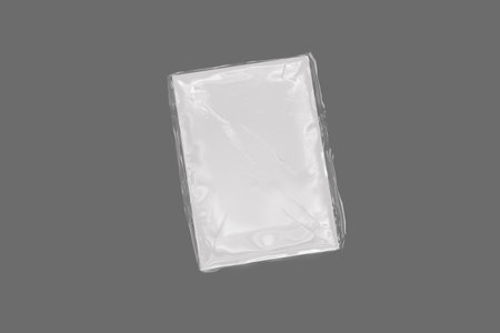 Blank white magazine packed in plastic bag. plastic wrapped magazine mockup isolated on a gray background. 3d rendering.の写真素材