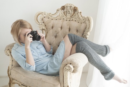 Lifestyle portrait of pretty young woman having fun with cameraの写真素材