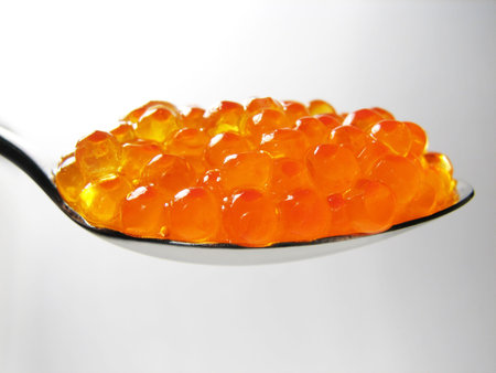red salmon caviar in spoon isolated and close-up