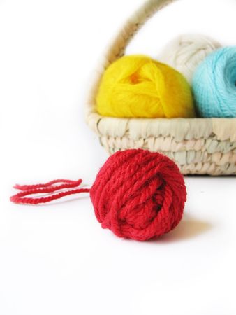 hank of the yarn for knitting in basket, focus on red hank, isolatedの写真素材