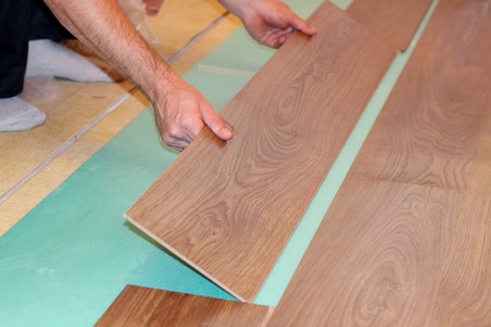 worker installing new laminate flooringの写真素材