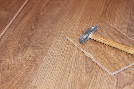 hammer and laminate plank on floorの写真素材