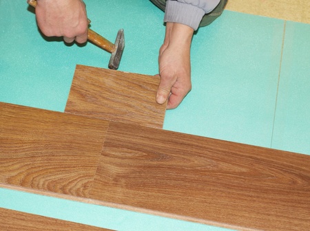 worker installing new laminate flooringの写真素材