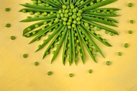 Green polka dots on a yellow backgroundの写真素材