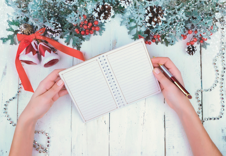 Christmas wooden white background with snow branch. Top view with copy space for your textの写真素材