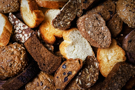 Assortment of baked bread on wooden table backgroundの写真素材