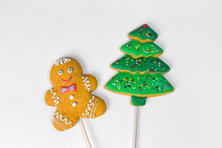 Christmas homemade gingerbread man and a tree cookies on a white background.の写真素材