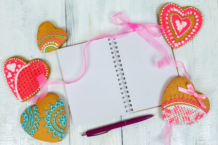 A hearty gingerbread cookie for Valentine's Day or a romantic event on a wooden table. Top view, copy spaceの写真素材