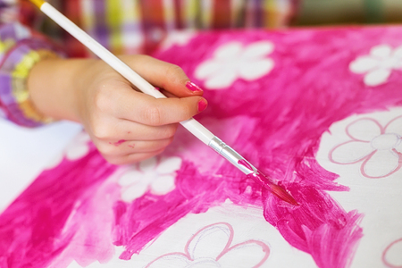 childrens hands draw a house for dolls. child creativity Place for textの写真素材