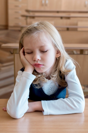 School girl sleeping at the school is sleep at the desk. Student. Pupil studyingの写真素材