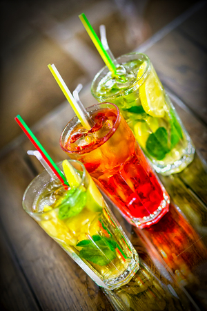Glasses of cocktails on bar backgroundの写真素材