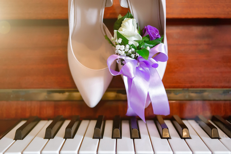 brides shoes on the piano, brides bouquet. wedding attributes.の写真素材