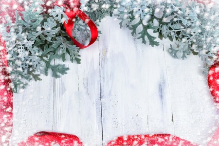Christmas wooden background with snow branch. Top view with copy space for your textの写真素材