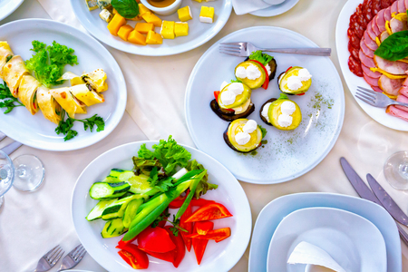 Served for a banquet table. Wine glasses with napkins, glasses and salads.の写真素材
