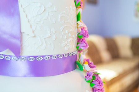 cake decoration. beautiful wedding cake with purple orchids. cake in violet tonesの写真素材