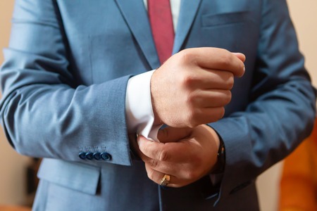 A set of clothes for the groom. Wedding shoes, belt, tie, perfume, cufflinks. The whole set of men is made in brown color. Luxury suite for real menの写真素材